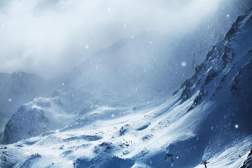 Aerial view of snowy mountains at winter day. Stormy weather, Canillo ski region, Andorra