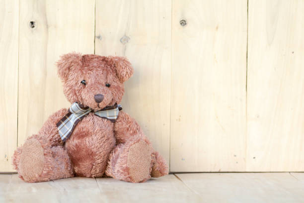 istock Teddy bear sitting on the wooden floor. 873577058