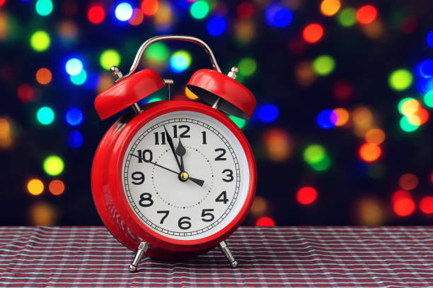 istock Red retro alarm clock at twelve o'clock 873577738