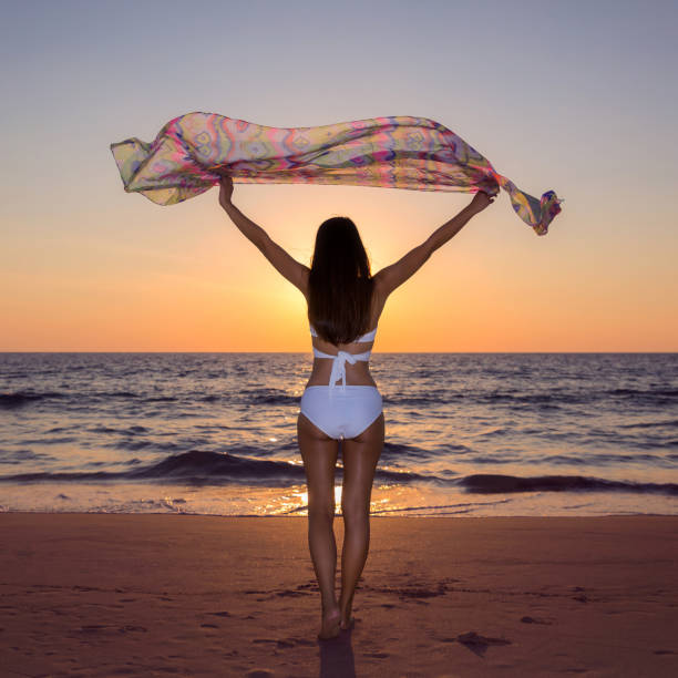 istock Woman relaxing on the beach 873580650