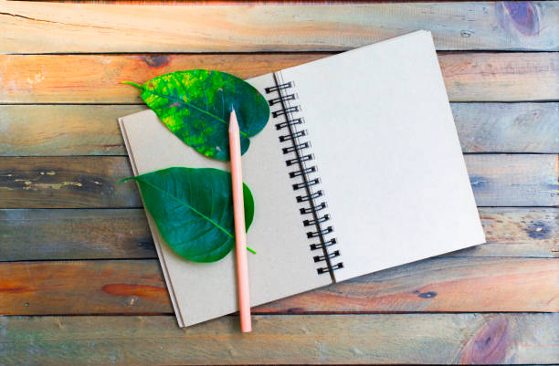 istock Notepad with pencil on wood board background.using wallpaper for education, business photo.Take note of the product for book with paper and concept, object or copy space. 873580916