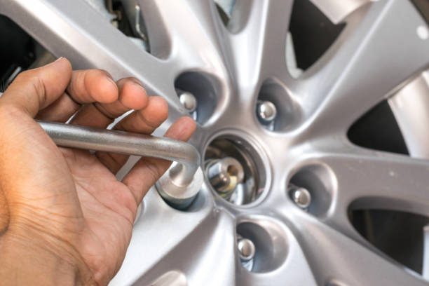 istock Men removing wheel for maintenance or repair image. 873580946