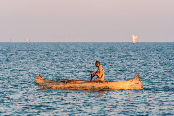 Sabang, Pulau Weh, Indonesia - January 12th 2024:  Outrigger canoe laying under some bushes close to the beach