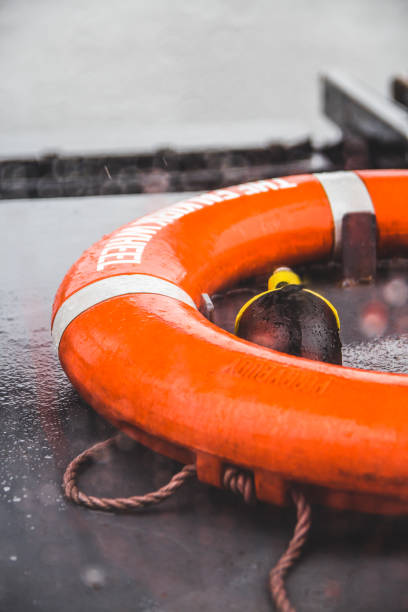 Orange life preserver on a boat during a rain storm, shallow depth of field stock photo