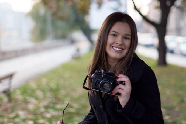 istock Girl with retro film camera 873586434