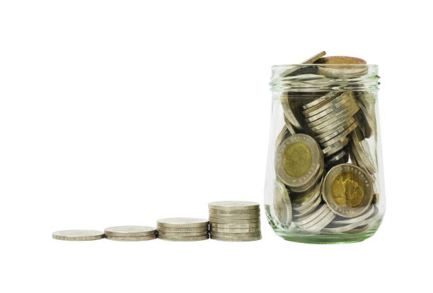 istock Thai baht coin stacking growth full over glass bottle isolated on white background with clipping path. saving, financial, business and investment concept. 873591106