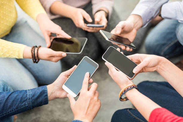 istock Friends having fun together with smartphones. 873591386