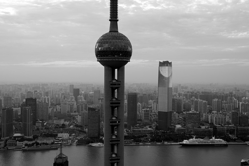Oriental Pearl Tower and sprawling Shanghai cityscape at sunset.  Black and white.