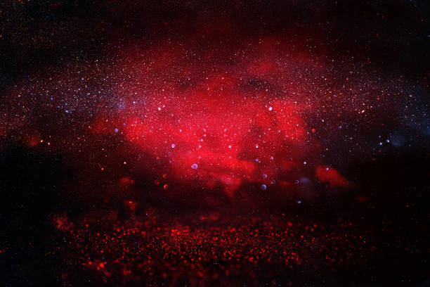 istock black and red glitter lights background. defocused 873597294