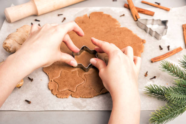 istock Woman hands cut cookies from raw dough. 873597452