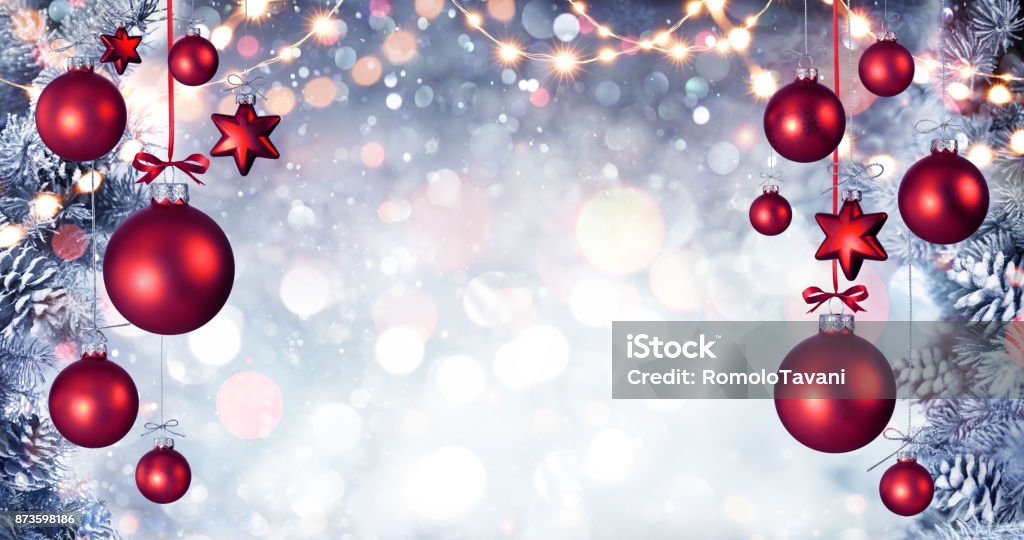 Red Christmas Balls Hanging With Snowy Fir branches And String Lights Red Spheres Hanging With Pine branches And String Lights Christmas Stock Photo