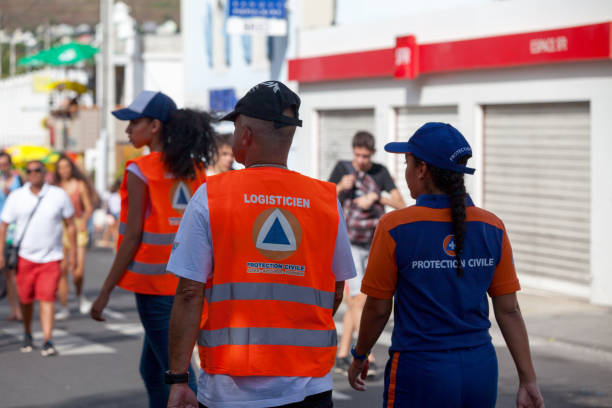 Civil Protection Patrol Saint-Gilles les bains, La Réunion - June 25 2017: Three officers of the 'Protection Civile' (First Responder) on patrol during the carnival of the Grand Boucan. french civil protection stock pictures, royalty-free photos & images