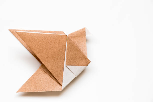 istock Brown origami paper in flying bird shape background 873601724