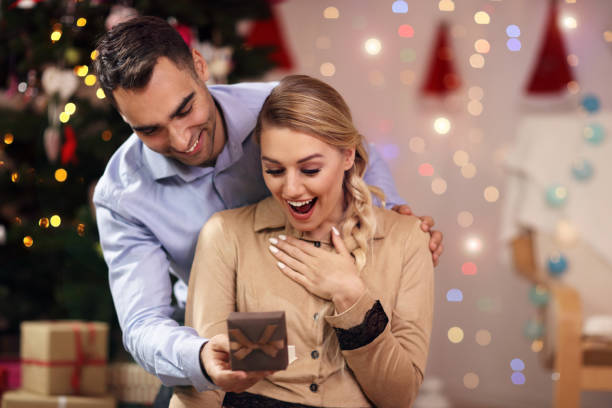 istock Happy Couple Opening Christmas Present 873607810