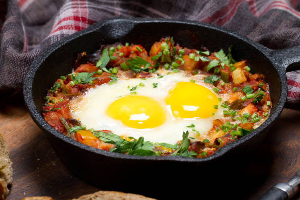 istock Country style fried eggs with vegetable salsa and parsley 873615826