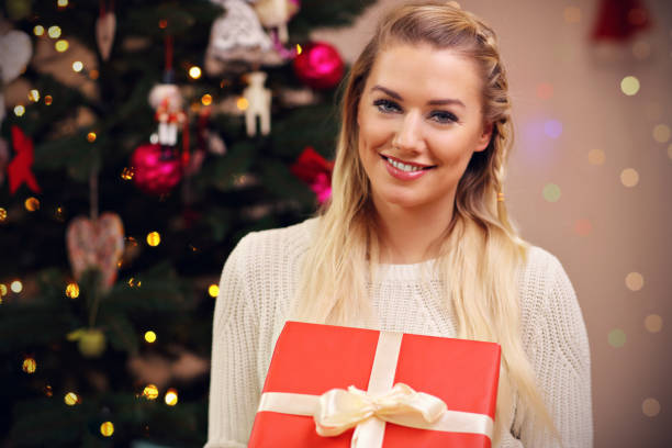 istock Happy woman posing with presents during Christmas time 873616382