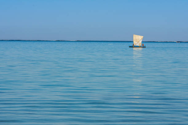 Tsifota, Madagascar, June 08, 2017:  Malagasy fishing sailboat of the Vezo ethnic group in the Ambatomilo lagoon in southwestern Madagascar