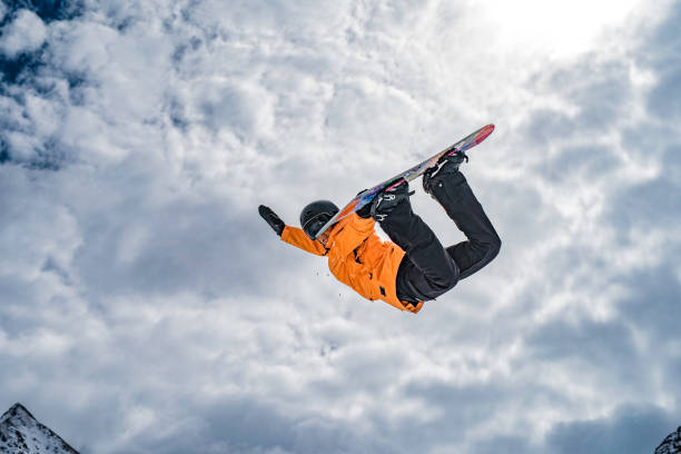 istock Female snowboarder doing a method grab in mid-air 873624406
