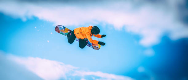 istock Female snowboarder in mid-air 873624690
