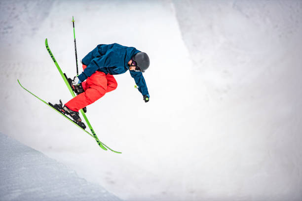 Freestyle skier in mid-air during a half pipe jump