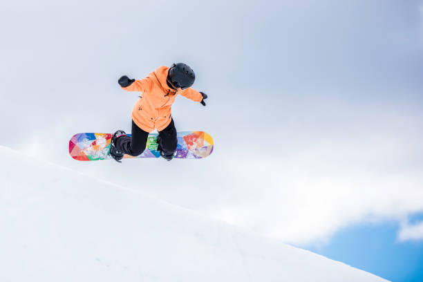 istock Female snowboarder in mid-air 873625088
