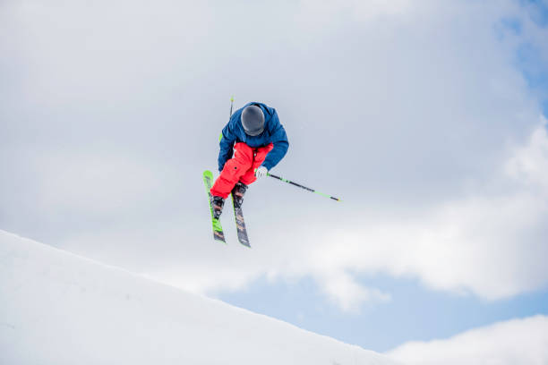 istock Freestyle skier in mid-air during a half pipe jump 873625216