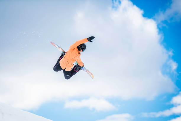 istock Female snowboarder in mid-air 873625262