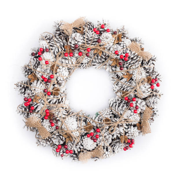 istock Christmas wreath decorated with pine cones, snow and red berries 873628432