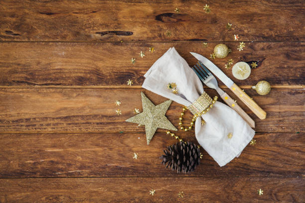 istock Christmas and New Year table place setting over wooden background. Copy space 873628458