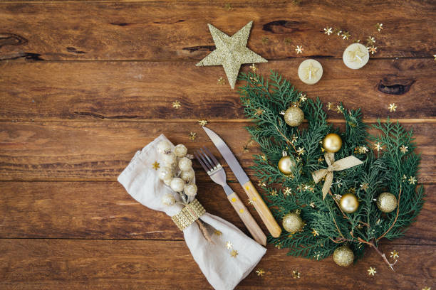 istock Christmas and New Year table place setting over wooden background. Copy space 873628460