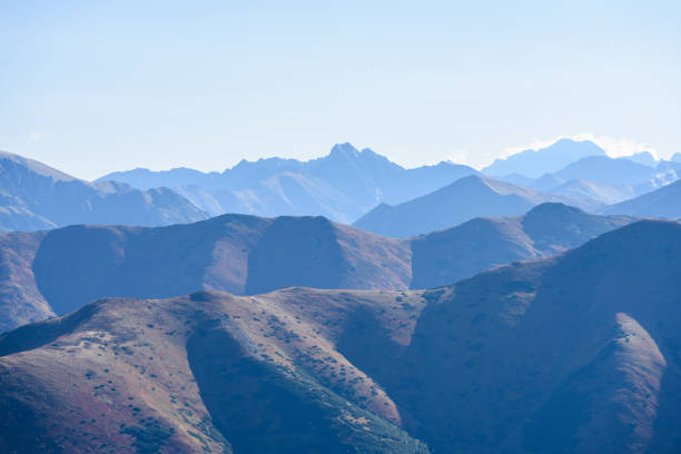 western carpathian mountain tops in  autumn covered in mist or clouds