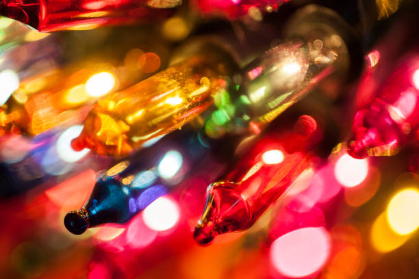 istock Christmas tree lights bulbs closeup on bokeh colorful 873632794