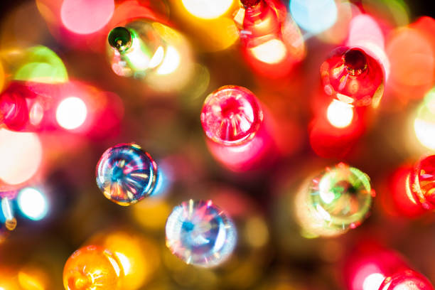 istock Christmas tree lights bulbs closeup on bokeh colorful 873632798