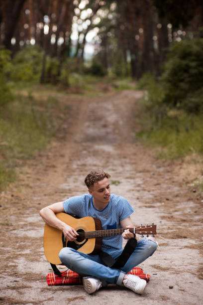 istock Music lifestyle man playing guitar nature concept. 873635626