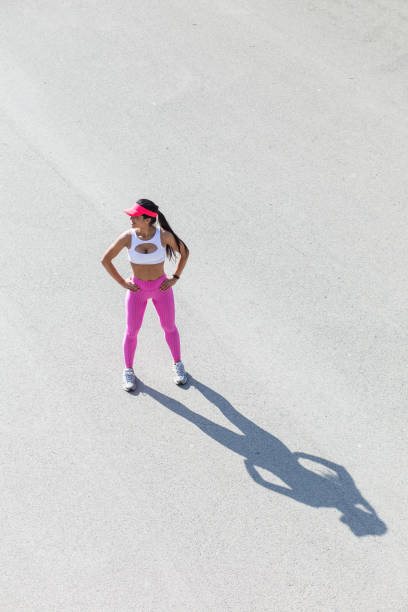 istock Fit middle-aged woman resting after training in park 873636828