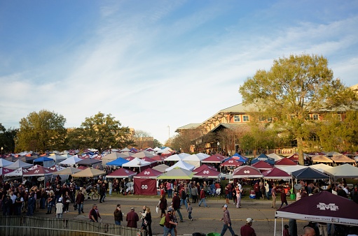 Mississippi State, Mississippi, USA - November 11, 2017: Fans tailgating in tents at the Mississippi State University versus The University of Alabama football game on the campus of Mississippi State near Davis Wade Stadium at Scott Field.