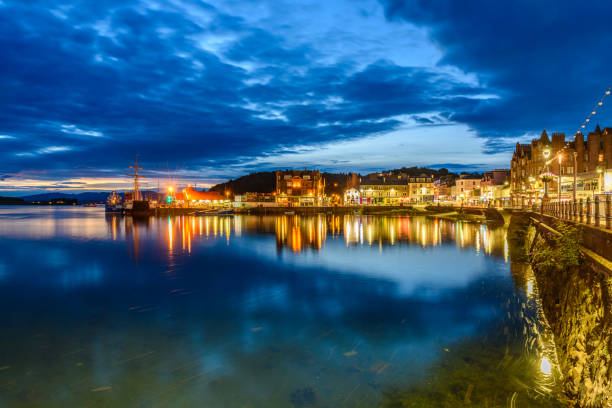 Cityscape of Oban Oban, Scotland - August 14, 2017: Night view of the bay of the beautiful town of Oban with lights reflection. oban stock pictures, royalty-free photos & images