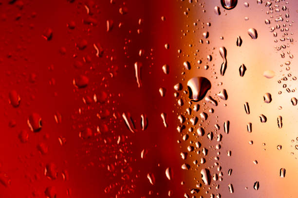 istock Drops on the glass rain red background 873646368