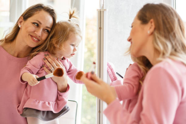istock Mom and baby in makeup room 873649778