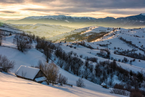 istock village in mountains on winter sunrise 873654316