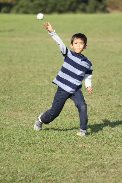 japanese boy playing catch (second grade at elementary school) - playing catch imagens e fotografias de stock