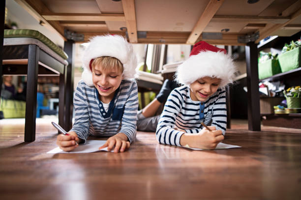 Little brothers writing letters to santa clasu