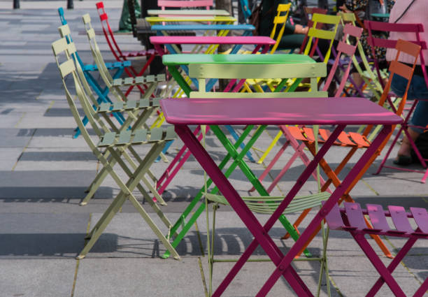 istock multicolored tables and chairs on the street in Aarhus Denmark 873666304