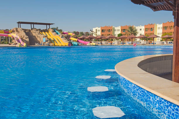 istock Swimming pool with bar in a luxury tropical hotel resort 873666340