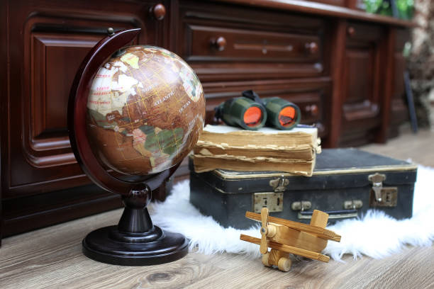 istock composition on a wooden floor vintage globe with old leather sui 873666738