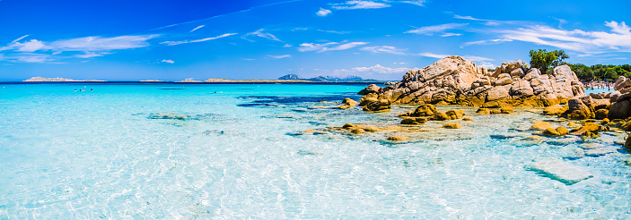 Clear amazing azure coloured sea water with granite rocks in Capriccioli beach, Sardinia, Italy.