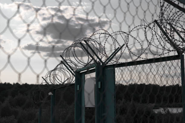 istock sign on a fence with barbed wire 873670422