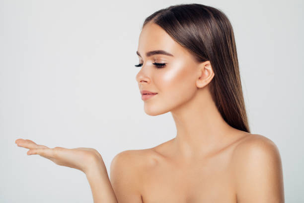 istock Beauty woman showing something 873678342