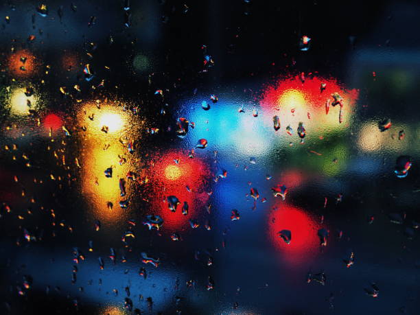 istock Rain drops on glass in urban environment. 873678434
