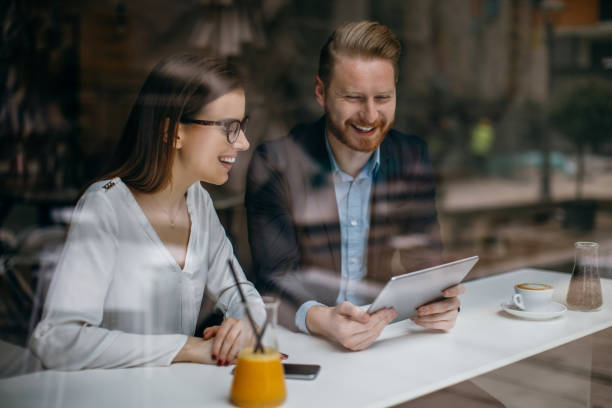 istock Young businesswoman and man having a conversation in cafe 873680920